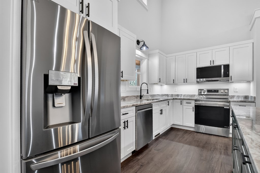 584 Brannon Nix Road Young Harris, GA 30582 - Photo 6 of 36 a kitchen with granite countertop a refrigerator stove and sink