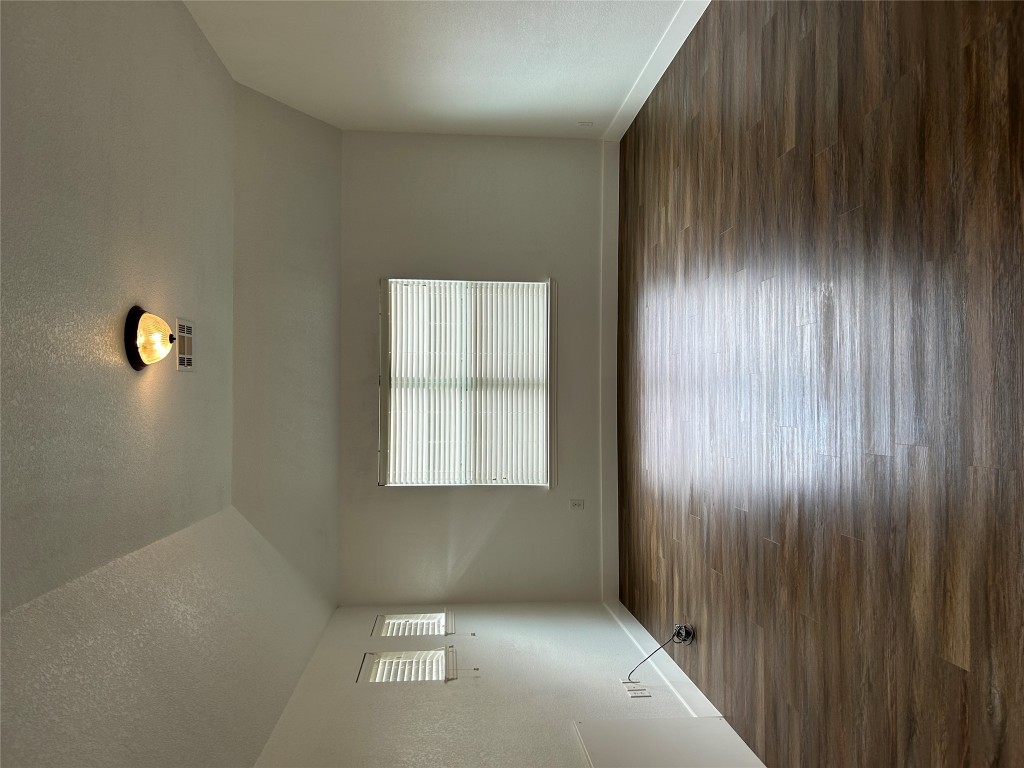 1374 Red Stag Place Round Rock, TX 78665 - Photo 14 of 15 a view of an empty room with wooden floor and a window