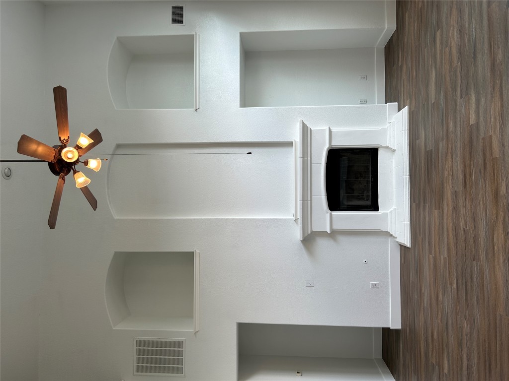 1374 Red Stag Place Round Rock, TX 78665 - Photo 4 of 15 a view of a livingroom with a fireplace a chandelier and wooden floor