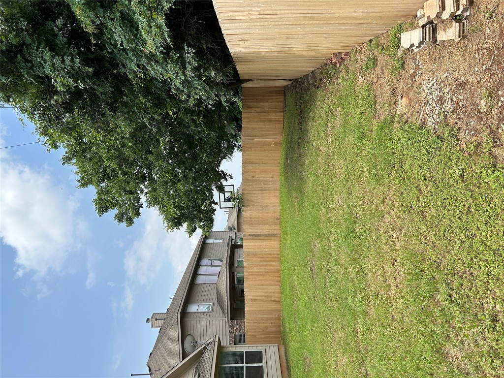 1374 Red Stag Place Round Rock, TX 78665 - Photo 9 of 15 a view of a backyard with a large tree and wooden fence