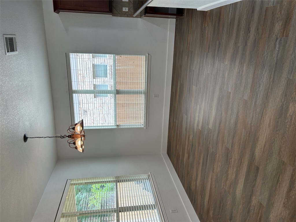 1374 Red Stag Place Round Rock, TX 78665 - Photo 10 of 15 an empty room with wooden floor and windows