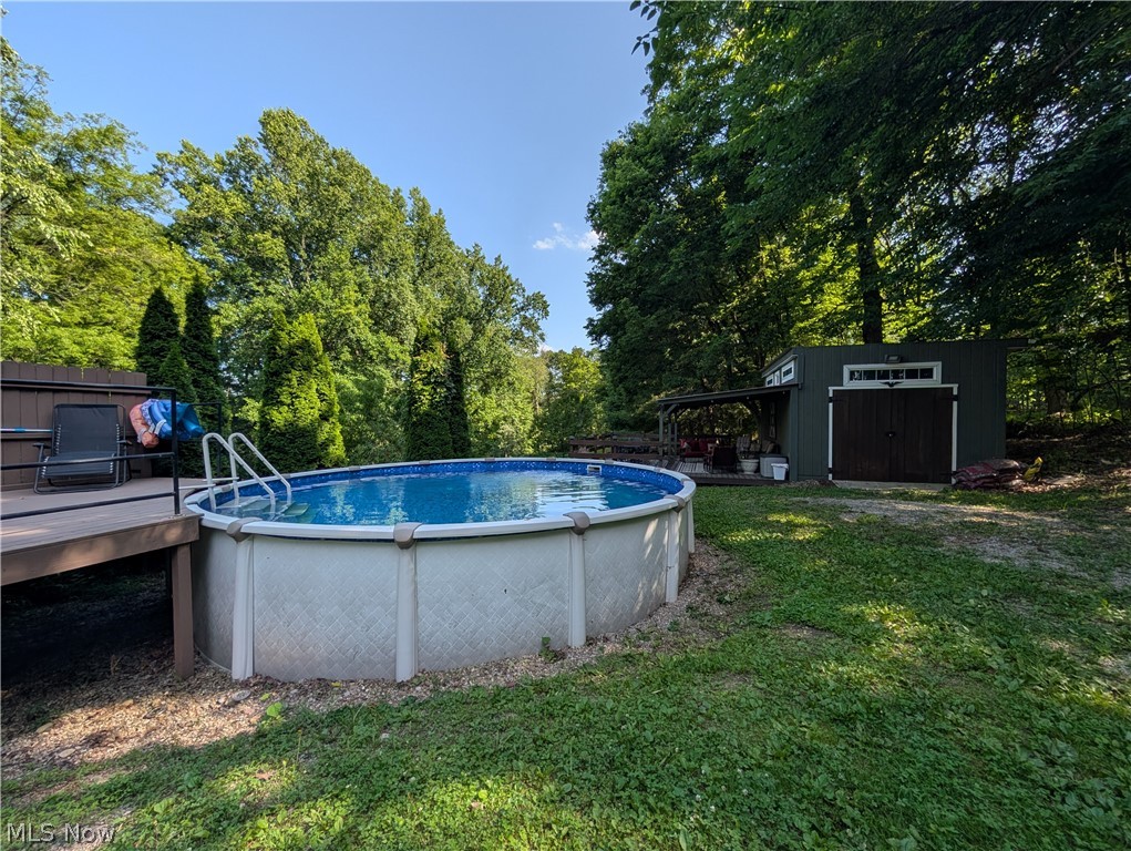 6700 McCaslin Road Nashport, OH 43830 - Photo 7 of 30 Above-ground swimming pool with an attached wood-finish deck