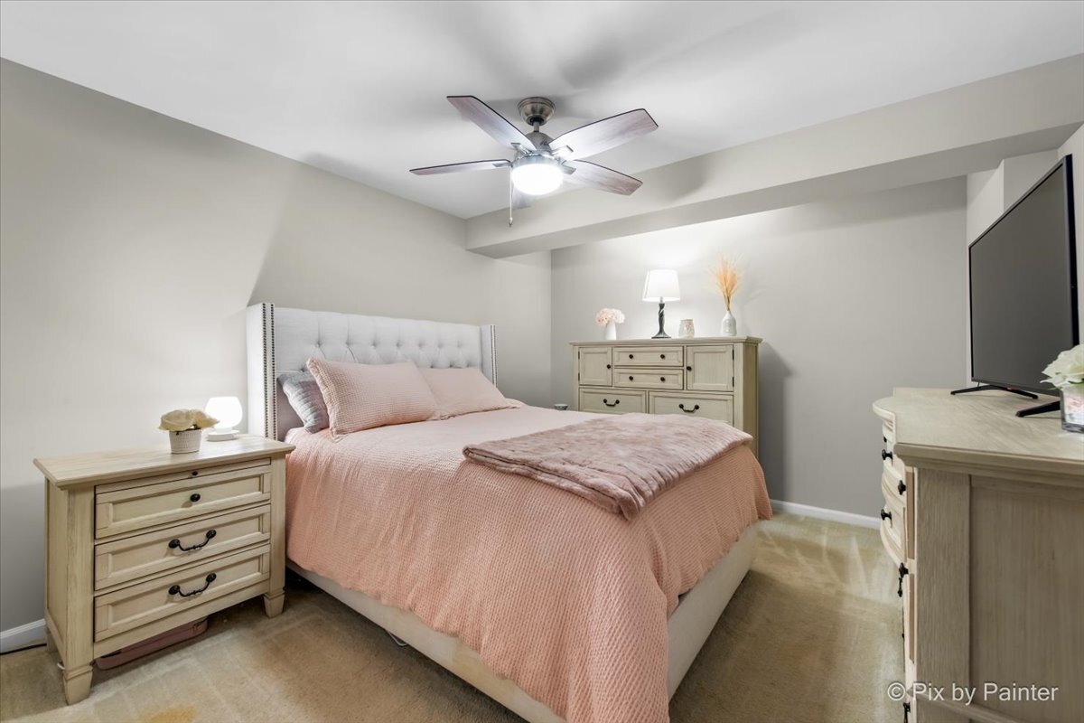 519 Shagbark Drive Elgin, IL 60123 - Photo 27 of 38 a bedroom with a bed and a flat tv screen on dresser