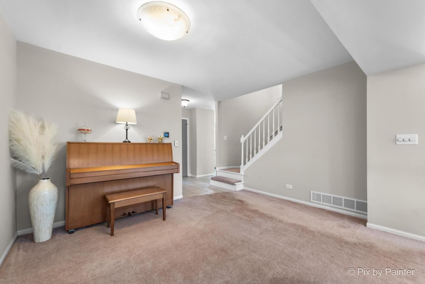 519 Shagbark Drive Elgin, IL 60123 - Photo 8 of 38 a living room with furniture and a chandelier