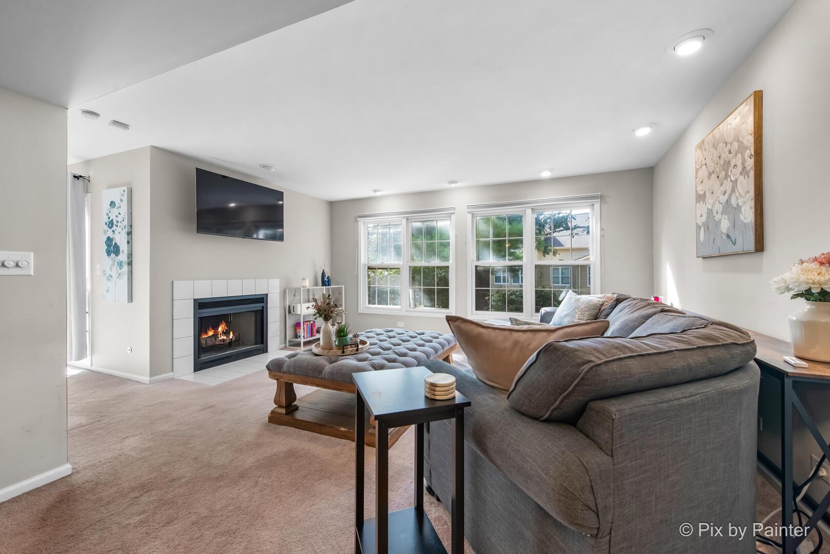 519 Shagbark Drive Elgin, IL 60123 - Photo 9 of 38 a living room with furniture a fireplace and a flat screen tv