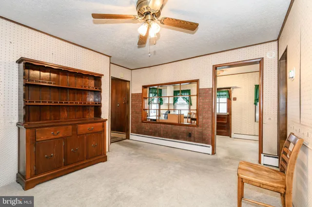a room with furniture and a ceiling fan