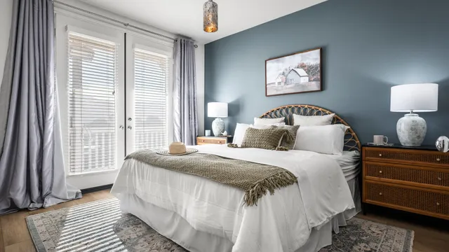 a bedroom with a bed and a large window