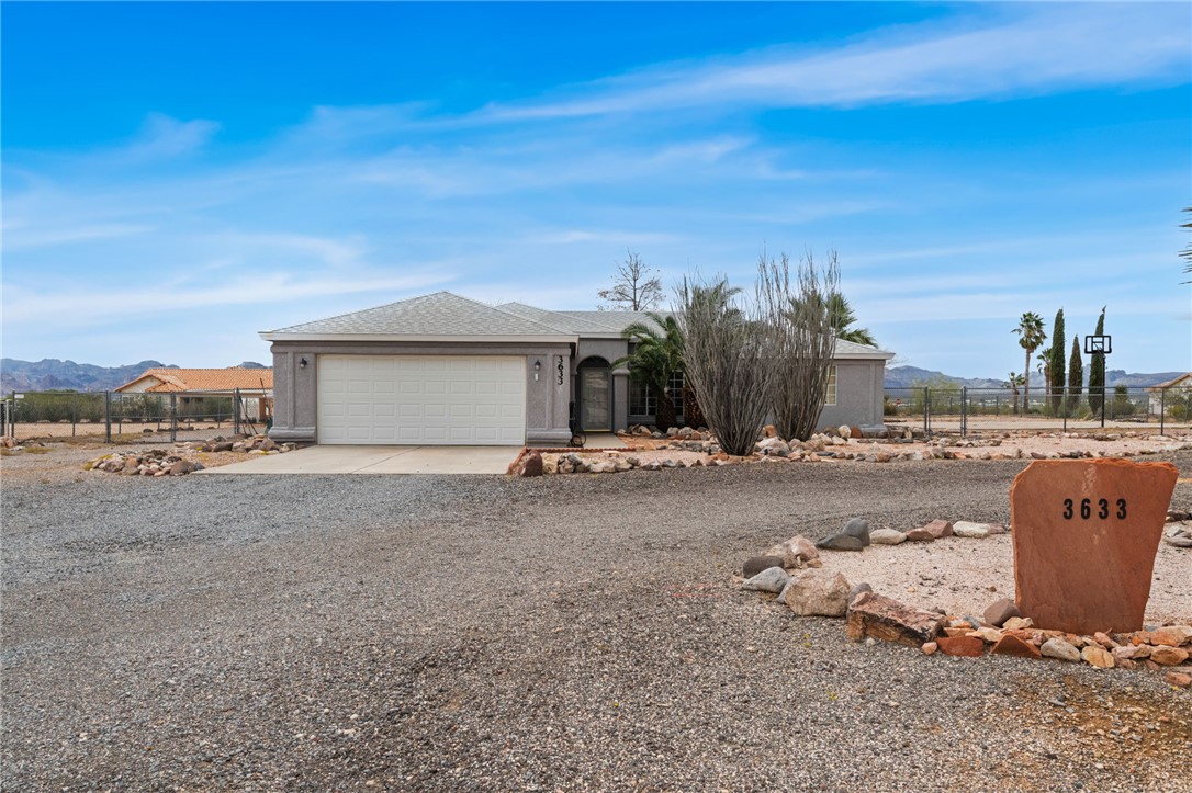 3633 Milky Way Road Golden Valley, AZ 86413 - Photo 1 of 28 View of front of property featuring a mountain view, circle driveway, a shingled roof