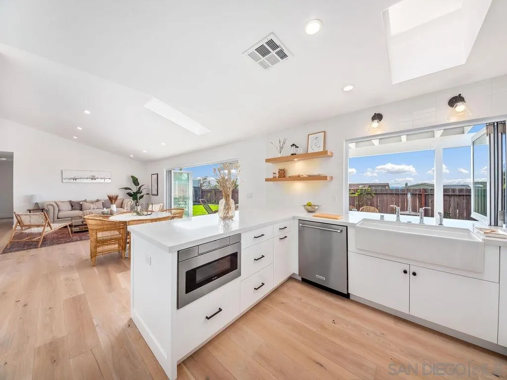 1710 Legaye Drive Cardiff, CA 92007 - Photo 12 of 43 a kitchen with cabinets a sink and appliances in it