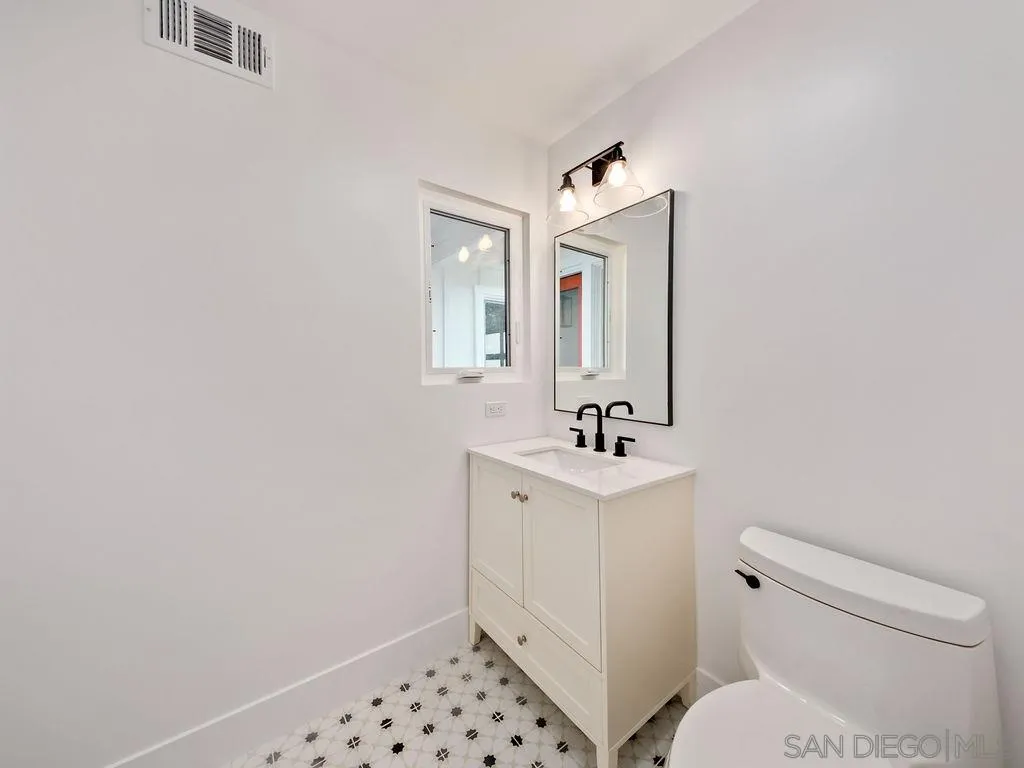 1710 Legaye Drive Cardiff, CA 92007 - Photo 32 of 43 a bathroom with a sink toilet and mirror