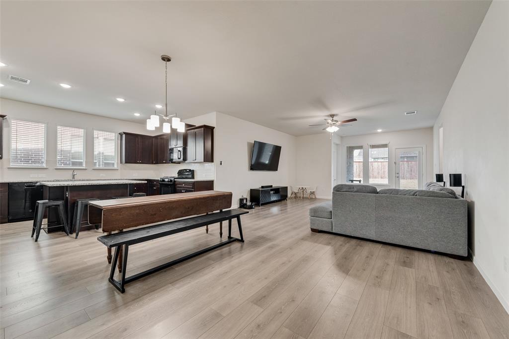 624 Hazeltine Road Red Oak, TX 75154 - Photo 11 of 37 a living room with furniture a table and kitchen view