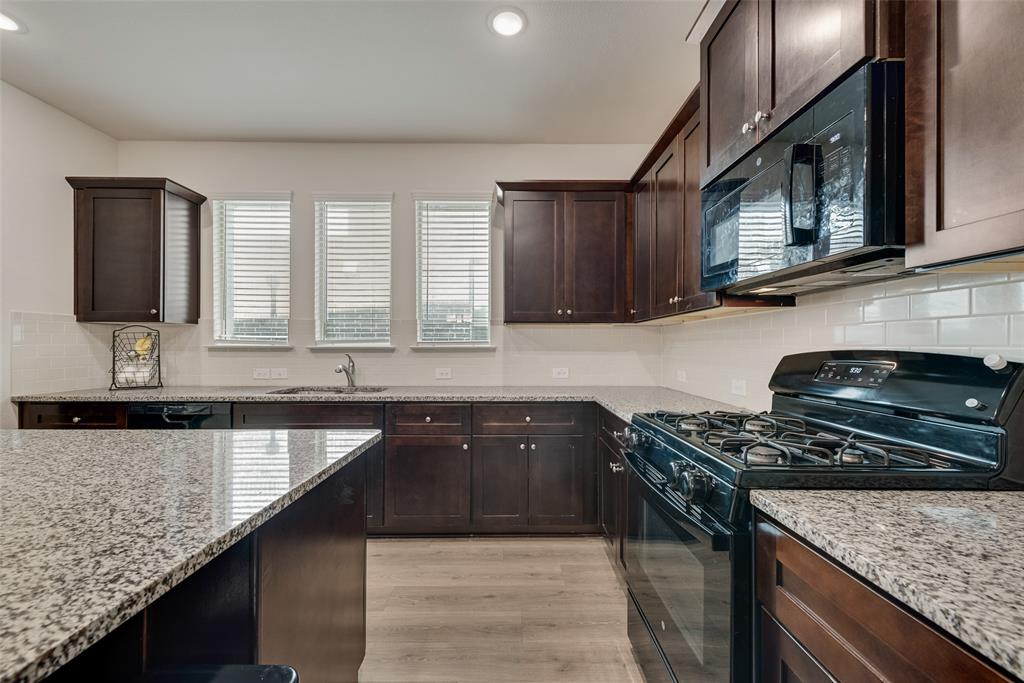 624 Hazeltine Road Red Oak, TX 75154 - Photo 18 of 37 a kitchen with granite countertop stainless steel appliances window a sink and a counter space