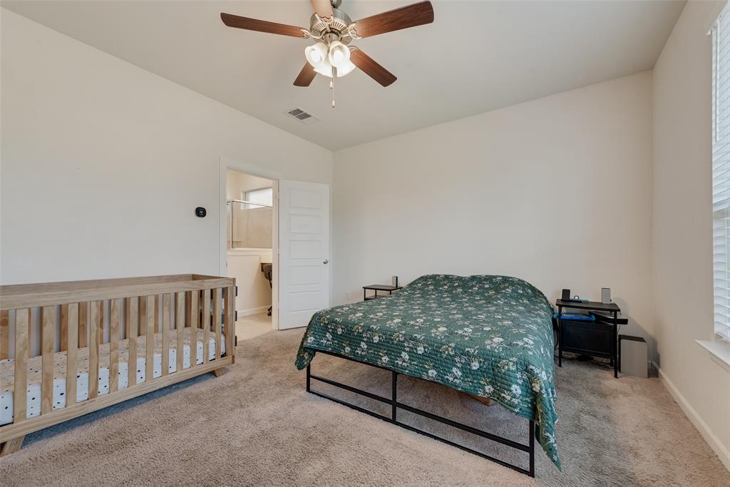 624 Hazeltine Road Red Oak, TX 75154 - Photo 22 of 37 a bedroom with furniture and a chandelier fan