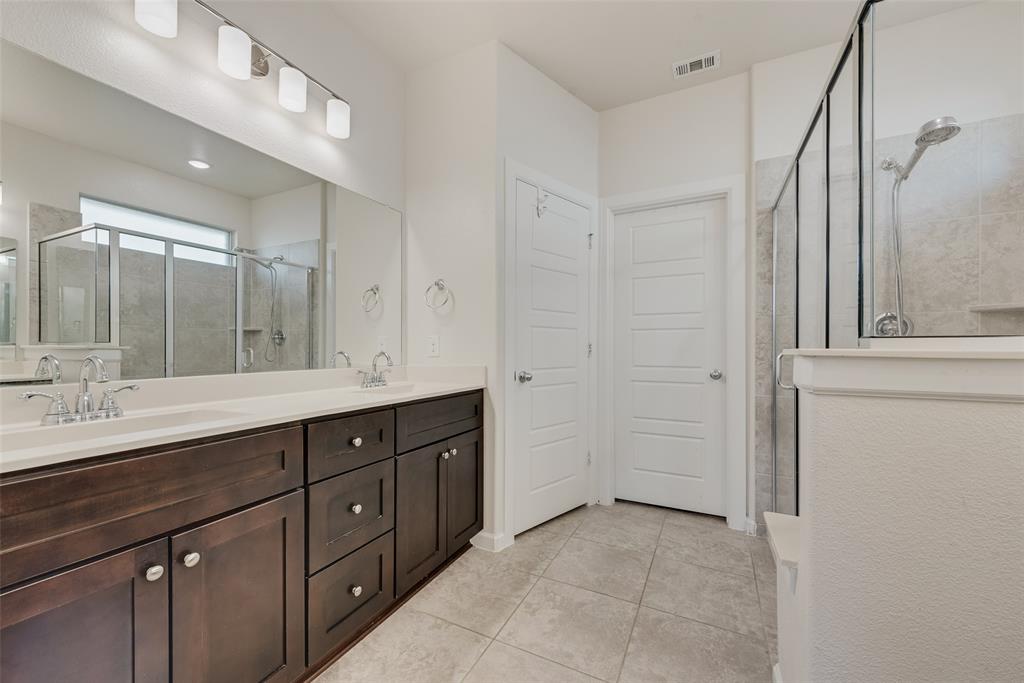 624 Hazeltine Road Red Oak, TX 75154 - Photo 24 of 37 a spacious bathroom with a double vanity sink a mirror and a shower