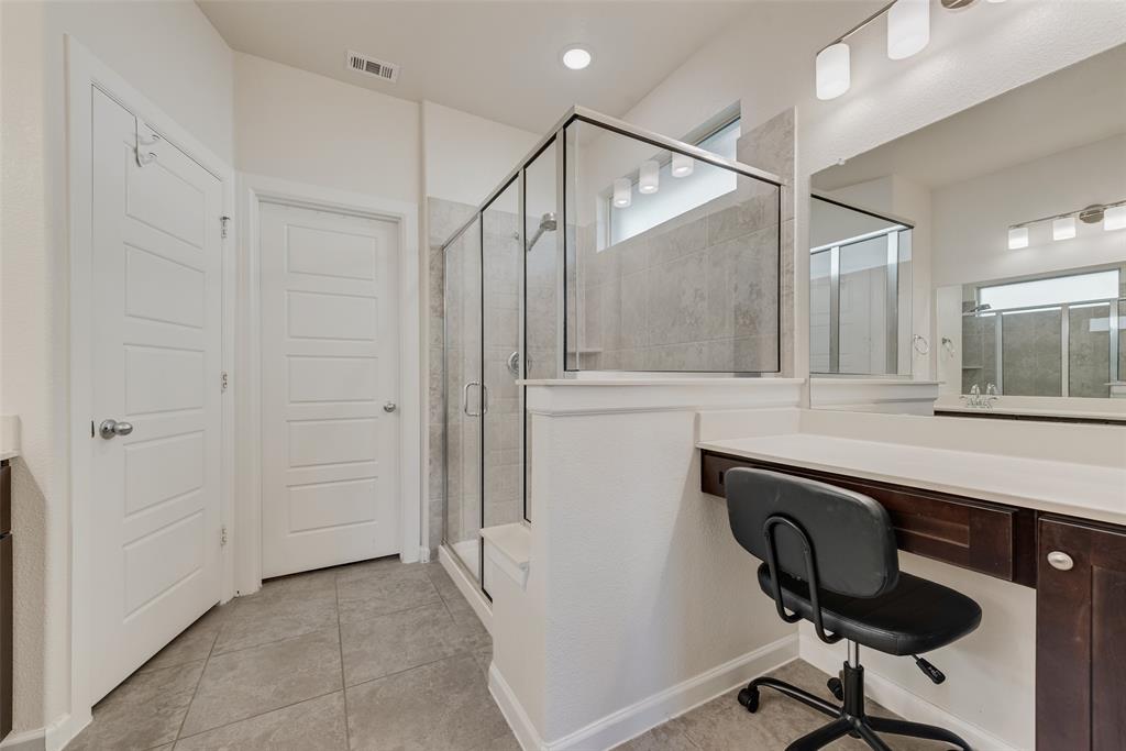 624 Hazeltine Road Red Oak, TX 75154 - Photo 25 of 37 a bathroom with a sink a mirror and a shower