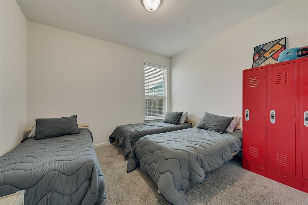 624 Hazeltine Road Red Oak, TX 75154 - Photo 26 of 37 a bedroom with two beds and a window