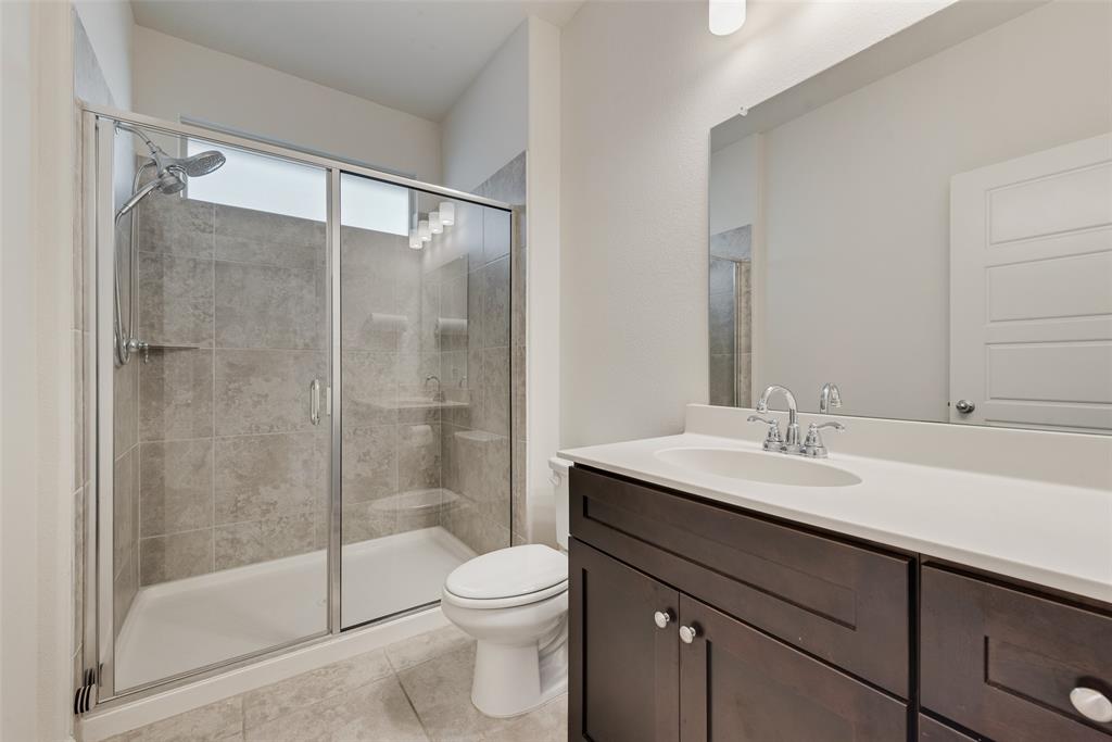 624 Hazeltine Road Red Oak, TX 75154 - Photo 32 of 37 a bathroom with a sink a toilet and shower