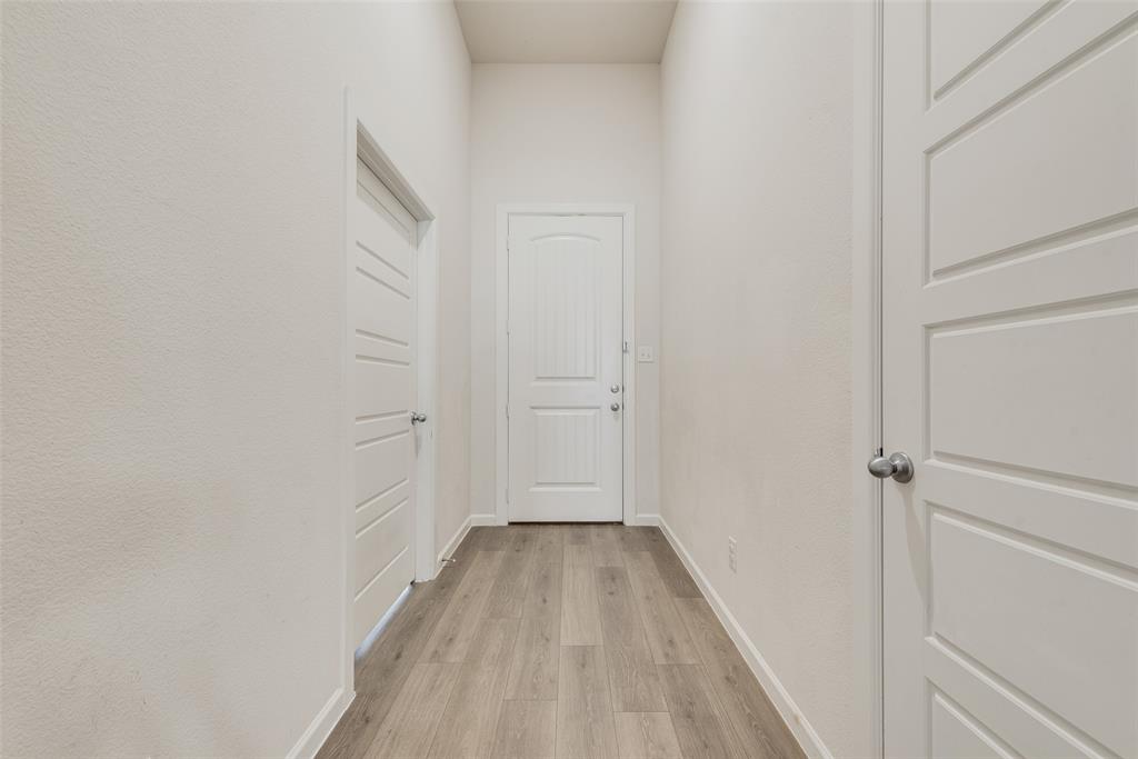 624 Hazeltine Road Red Oak, TX 75154 - Photo 7 of 37 a view of a hallway with wooden floor