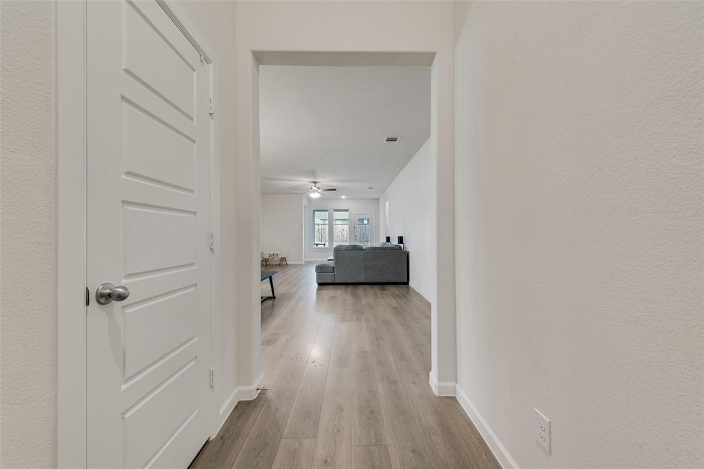 624 Hazeltine Road Red Oak, TX 75154 - Photo 8 of 37 a view of a hallway with wooden floor and closet