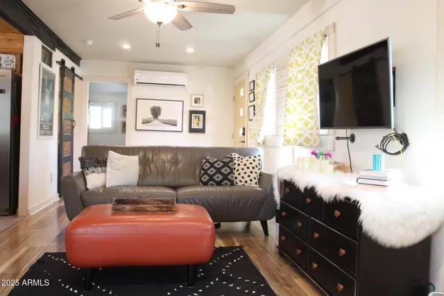 a living room with furniture and a flat screen tv