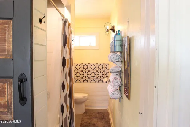 a bathroom with a toilet and shower