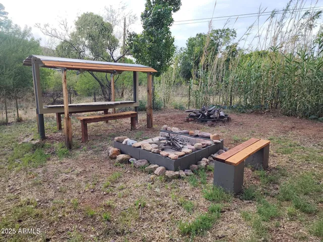 a view of a backyard with sitting area and garden
