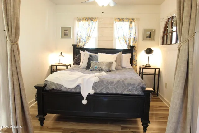 a large bed sitting in a bedroom next to a window