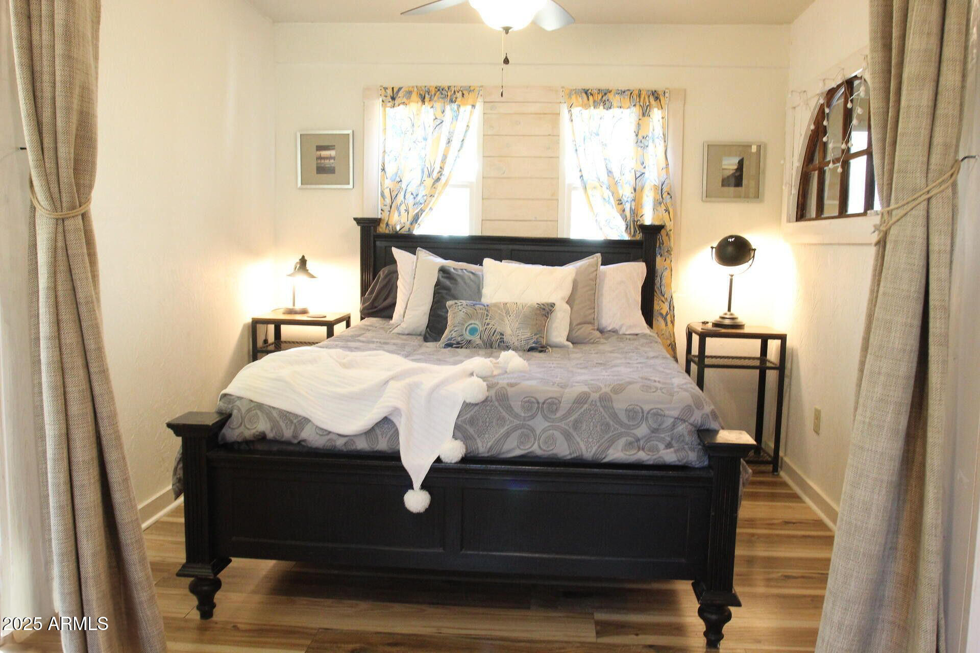 1 Arizona Street Bisbee, AZ 85603 - Photo 7 of 38 a large bed sitting in a bedroom next to a window