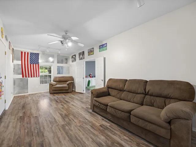 a living room with furniture and a ceiling fan