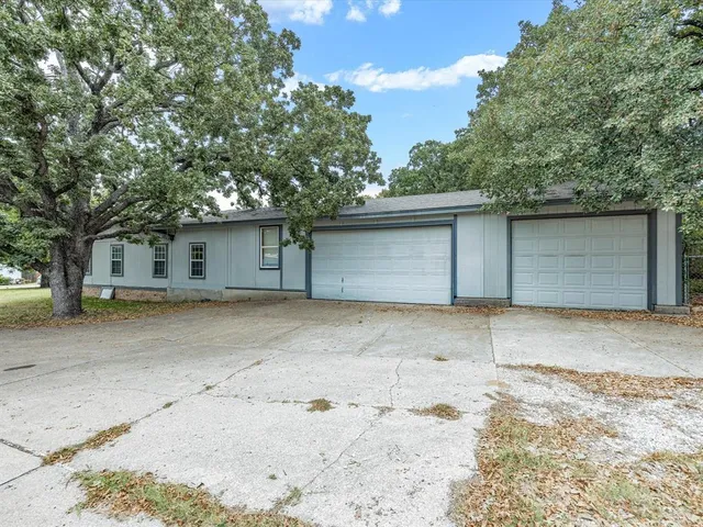 a view of a house with a yard and garage