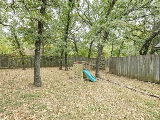 a backyard of a house with table and chairs