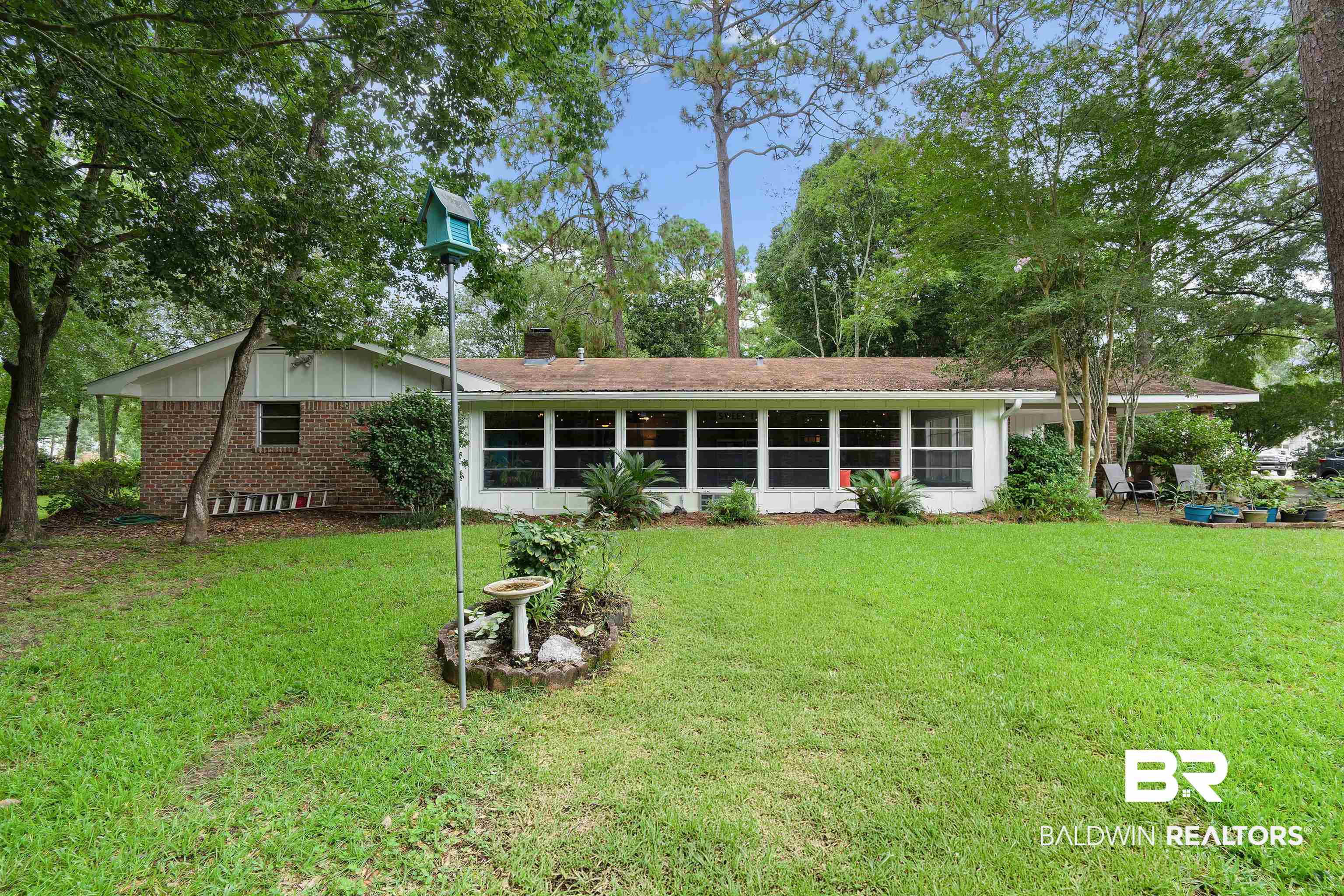 4051 East Canal Circle Mobile, AL 36619 - Photo 31 of 32 Rear view of property featuring a lawn