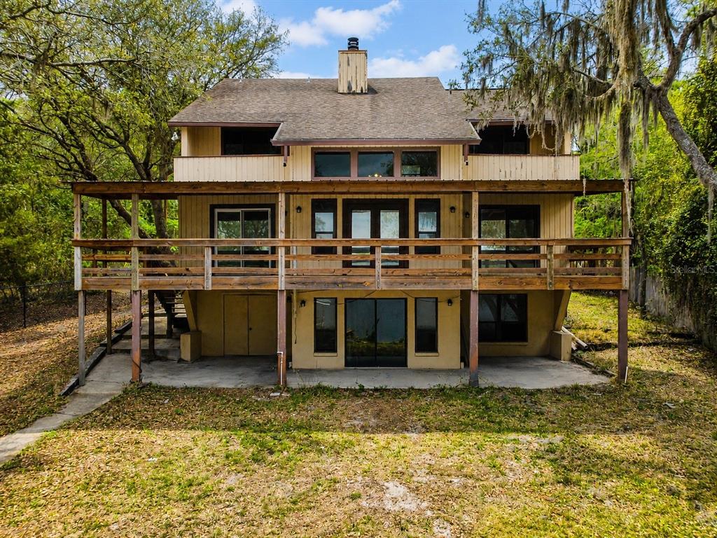 7119 Immokalee Road Keystone Heights, FL 32656 - Photo 45 of 50 a view of a house with a yard balcony and sitting area