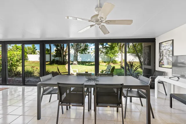 a view of a dining room with furniture large windows and wooden floor