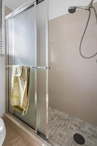 a bathroom with a glass shower door