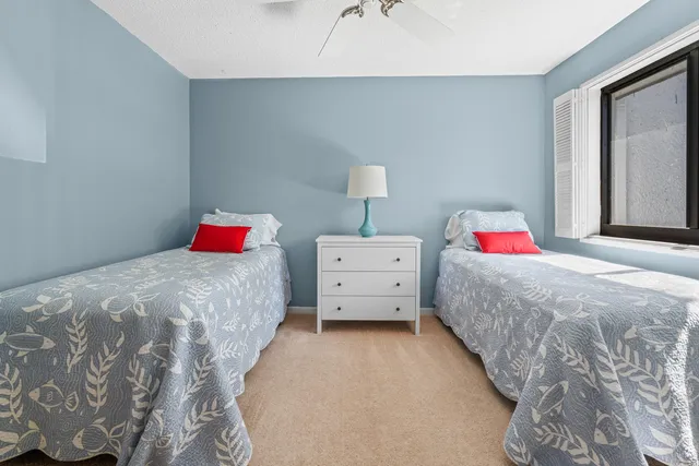 a view of a chair and tables in the patio in front of a house