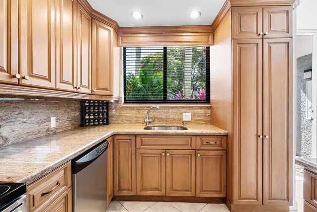a kitchen with granite countertop a sink and a window