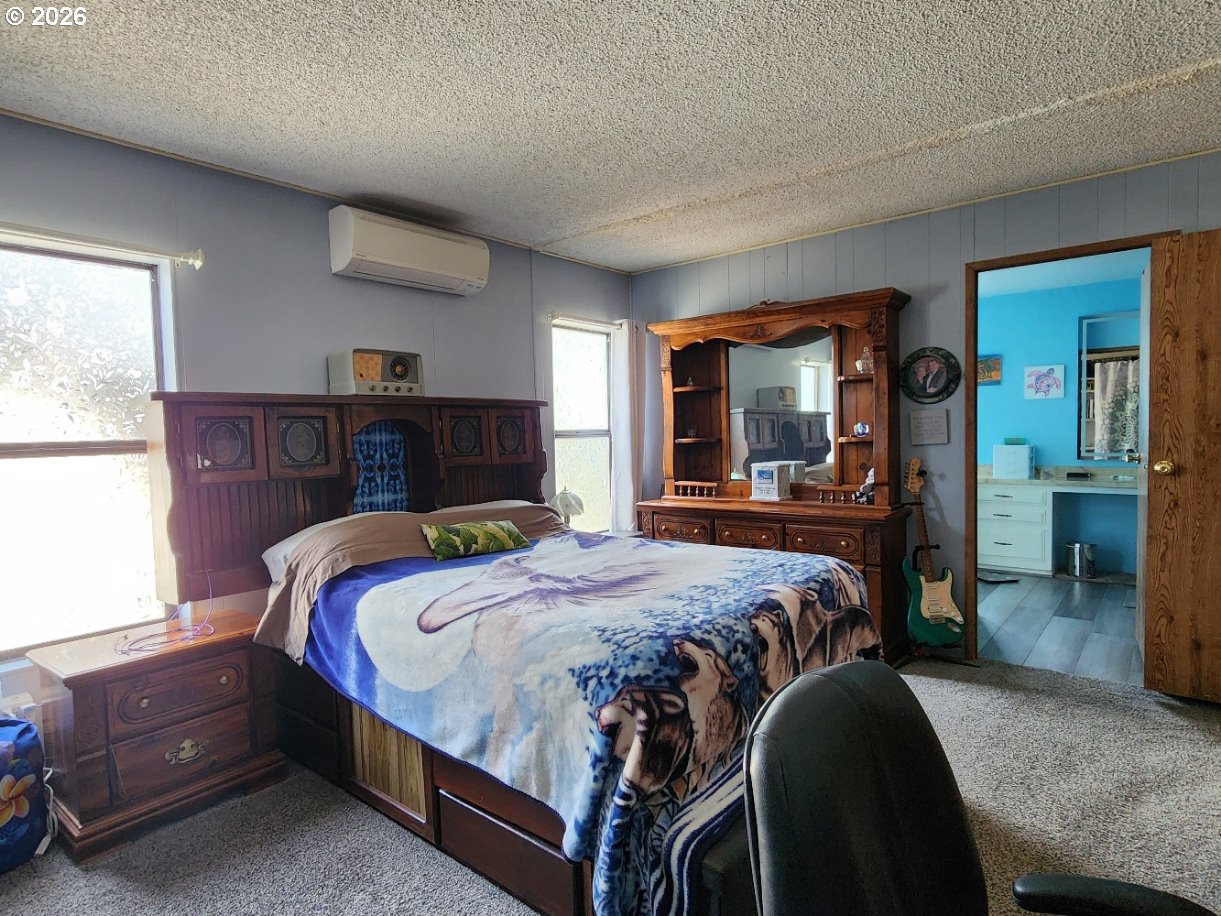 430 Birch Street Drain, OR 97435 - Photo 16 of 33 a bedroom with a bed and a dresser