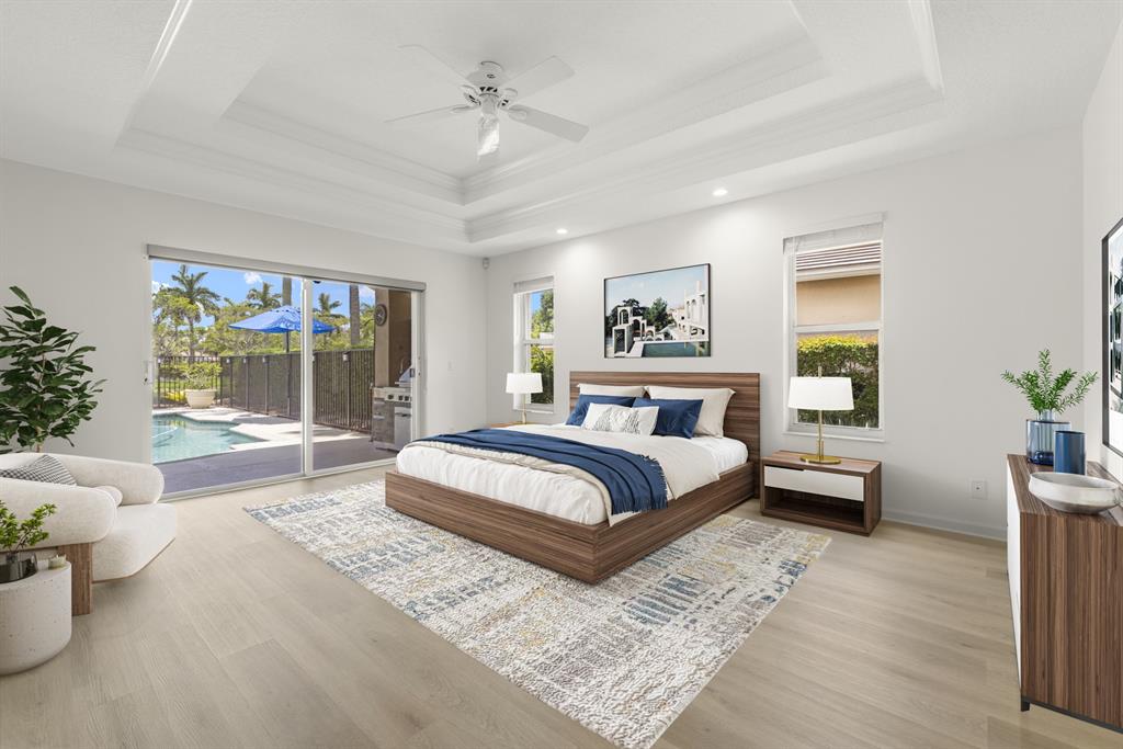 3707 Oak Ridge Circle Weston, FL 33331 - Photo 15 of 47 a bedroom with a large bed and a chandelier