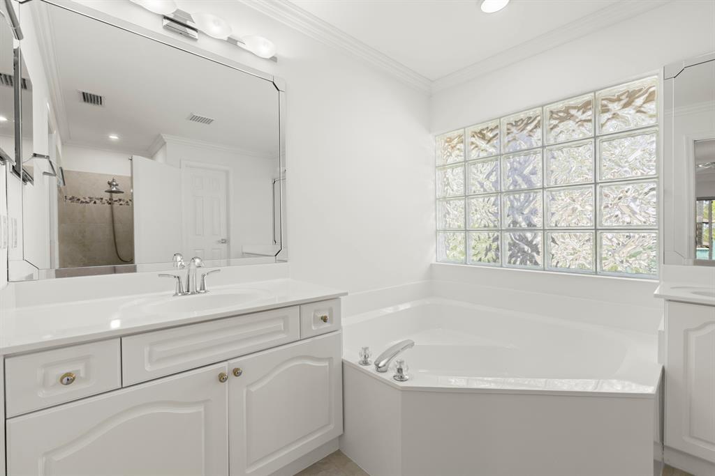 3707 Oak Ridge Circle Weston, FL 33331 - Photo 17 of 47 a bathroom with a bathtub a sink a vanity and a window