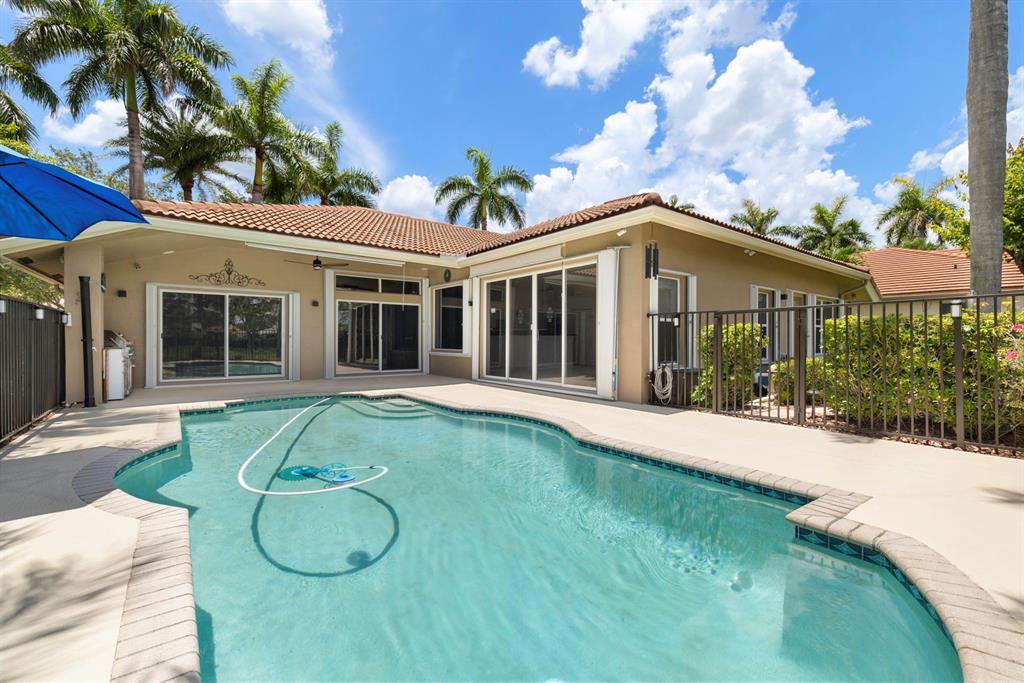 3707 Oak Ridge Circle Weston, FL 33331 - Photo 30 of 47 a view of a white house with a big yard and potted plants