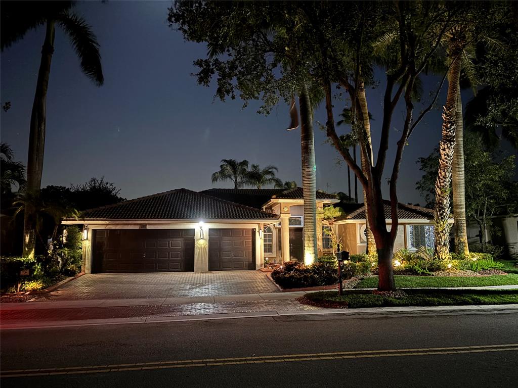 3707 Oak Ridge Circle Weston, FL 33331 - Photo 34 of 47 a front view of a house with a yard