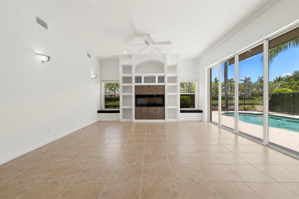 3707 Oak Ridge Circle Weston, FL 33331 - Photo 5 of 47 a view of an empty room with a fireplace and a window