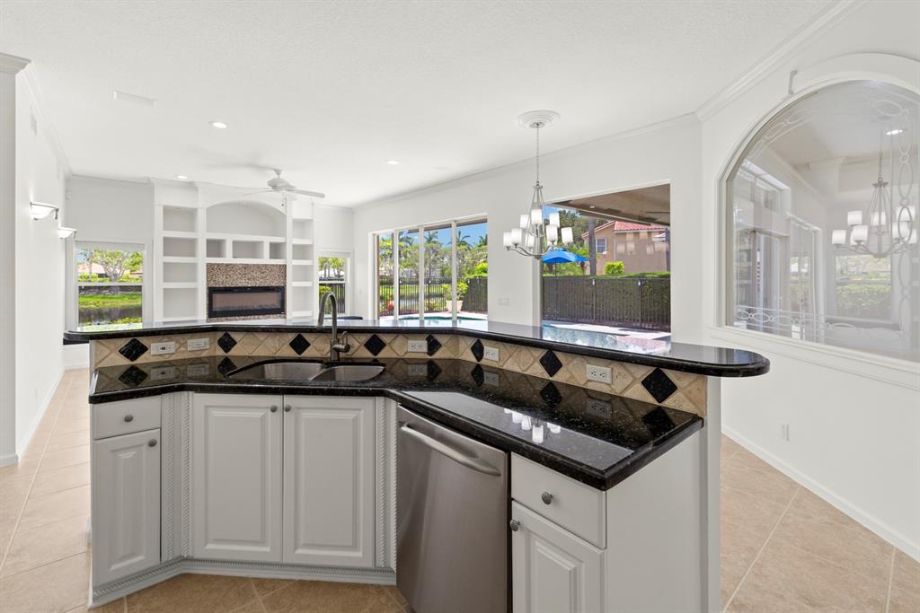 3707 Oak Ridge Circle Weston, FL 33331 - Photo 7 of 47 a kitchen with granite countertop a sink and cabinets