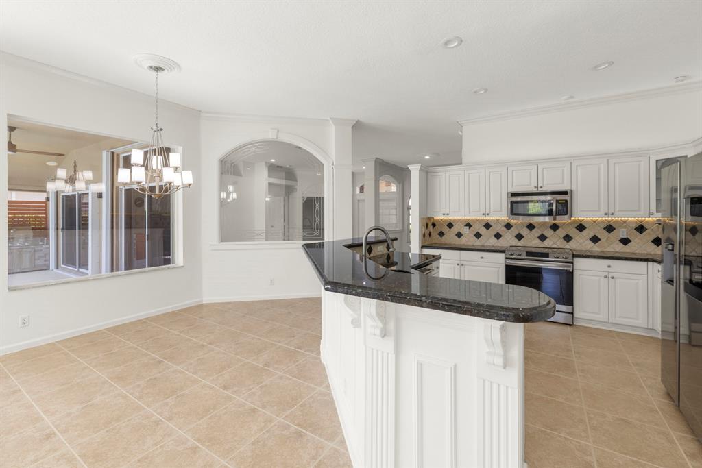 3707 Oak Ridge Circle Weston, FL 33331 - Photo 9 of 47 a kitchen with granite countertop a sink cabinets and stainless steel appliances