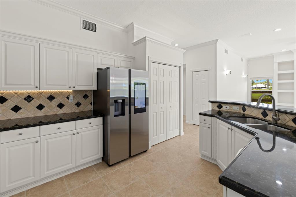 3707 Oak Ridge Circle Weston, FL 33331 - Photo 10 of 47 a kitchen with granite countertop a sink stove and refrigerator