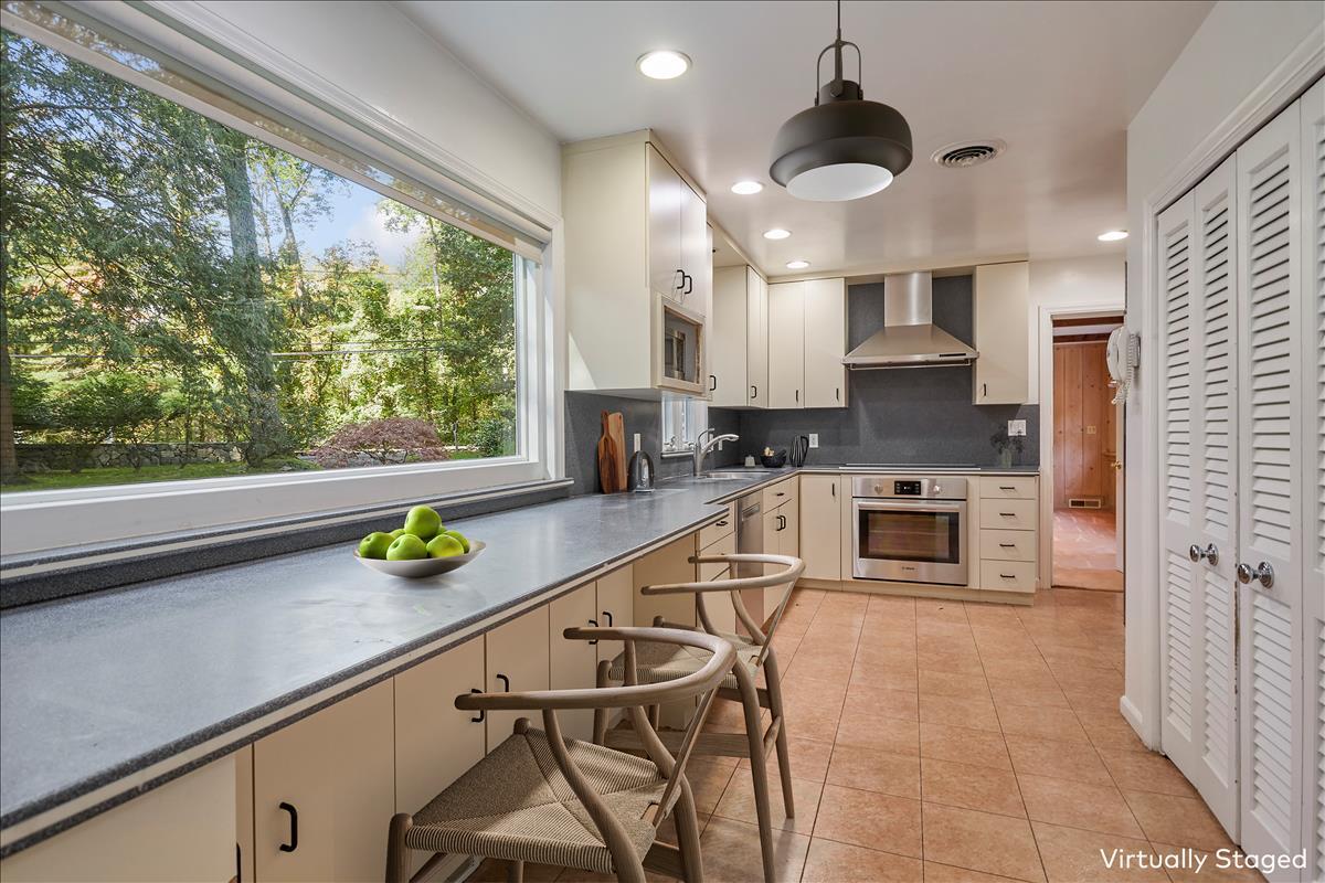 179 Hunting Ridge Road Stamford, CT 06903 - Photo 5 of 24 a kitchen with stainless steel appliances a sink a counter top space cabinets and a window