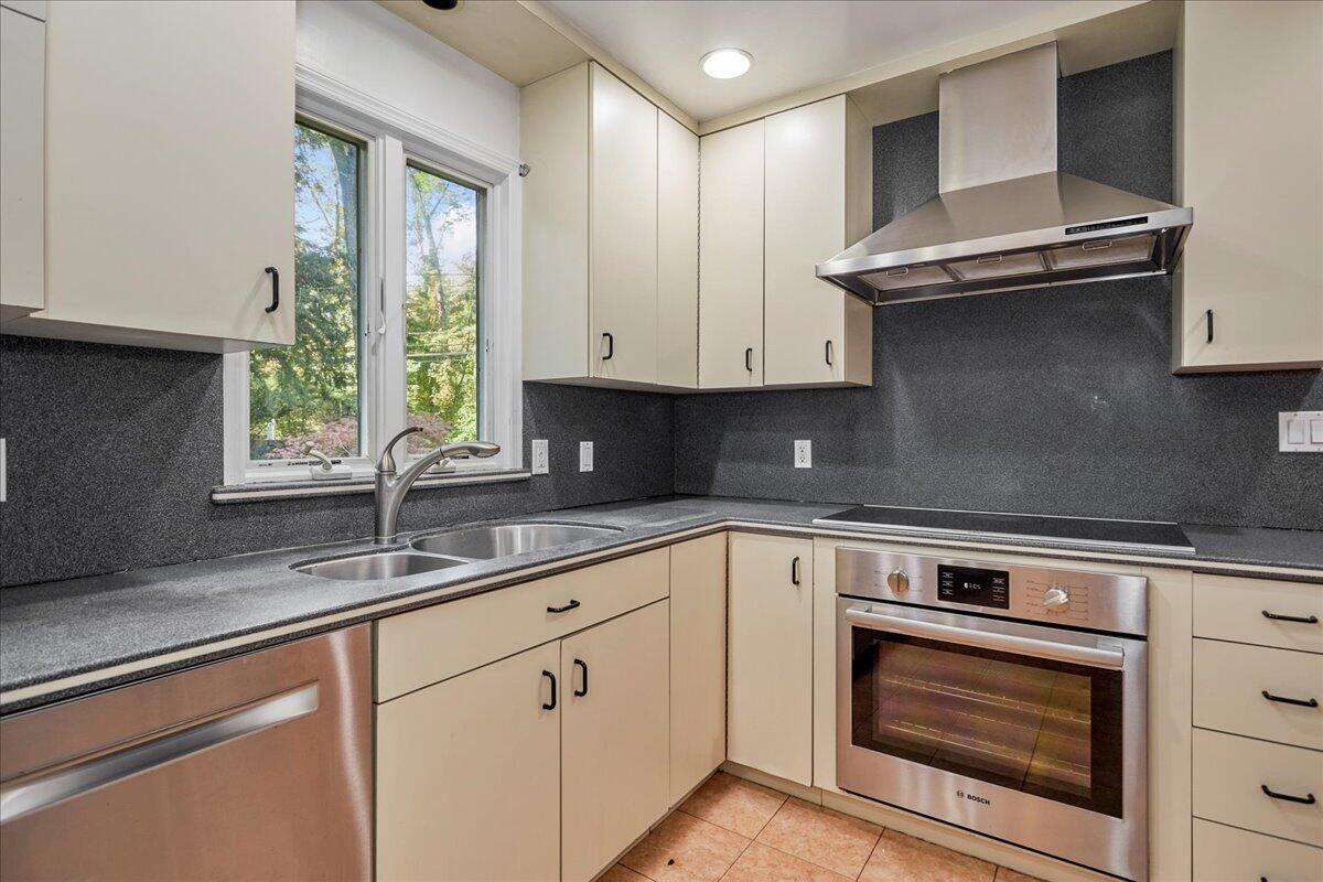 179 Hunting Ridge Road Stamford, CT 06903 - Photo 6 of 24 a kitchen with granite countertop white cabinets and white appliances