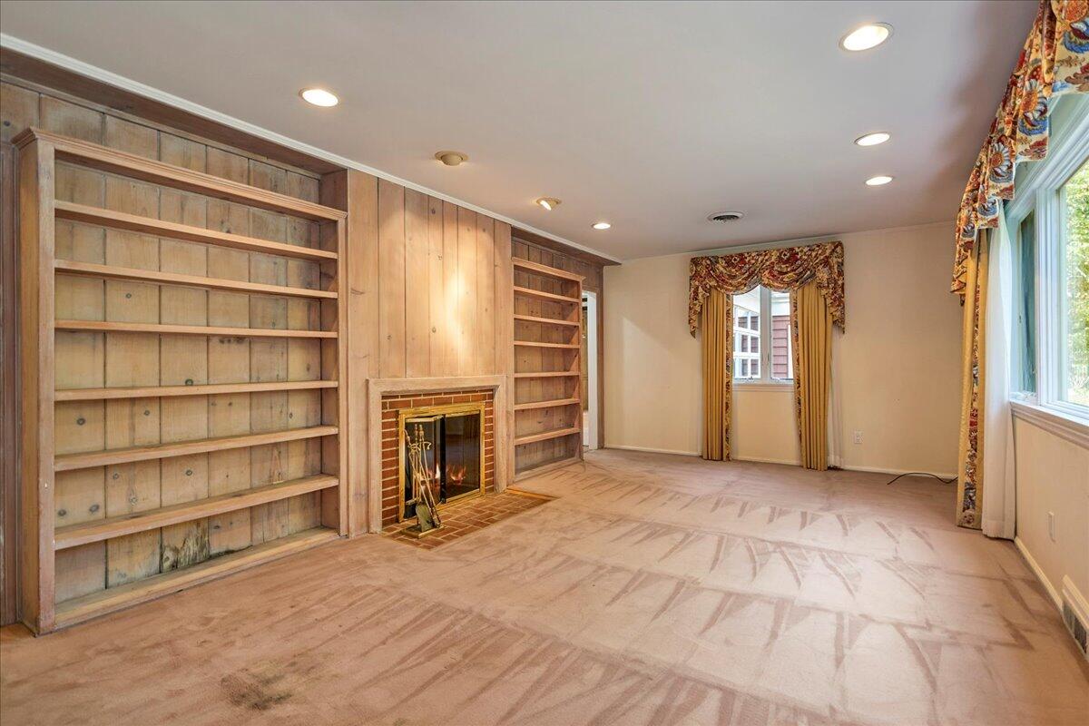 179 Hunting Ridge Road Stamford, CT 06903 - Photo 9 of 24 a view of an empty room with a fireplace and a window
