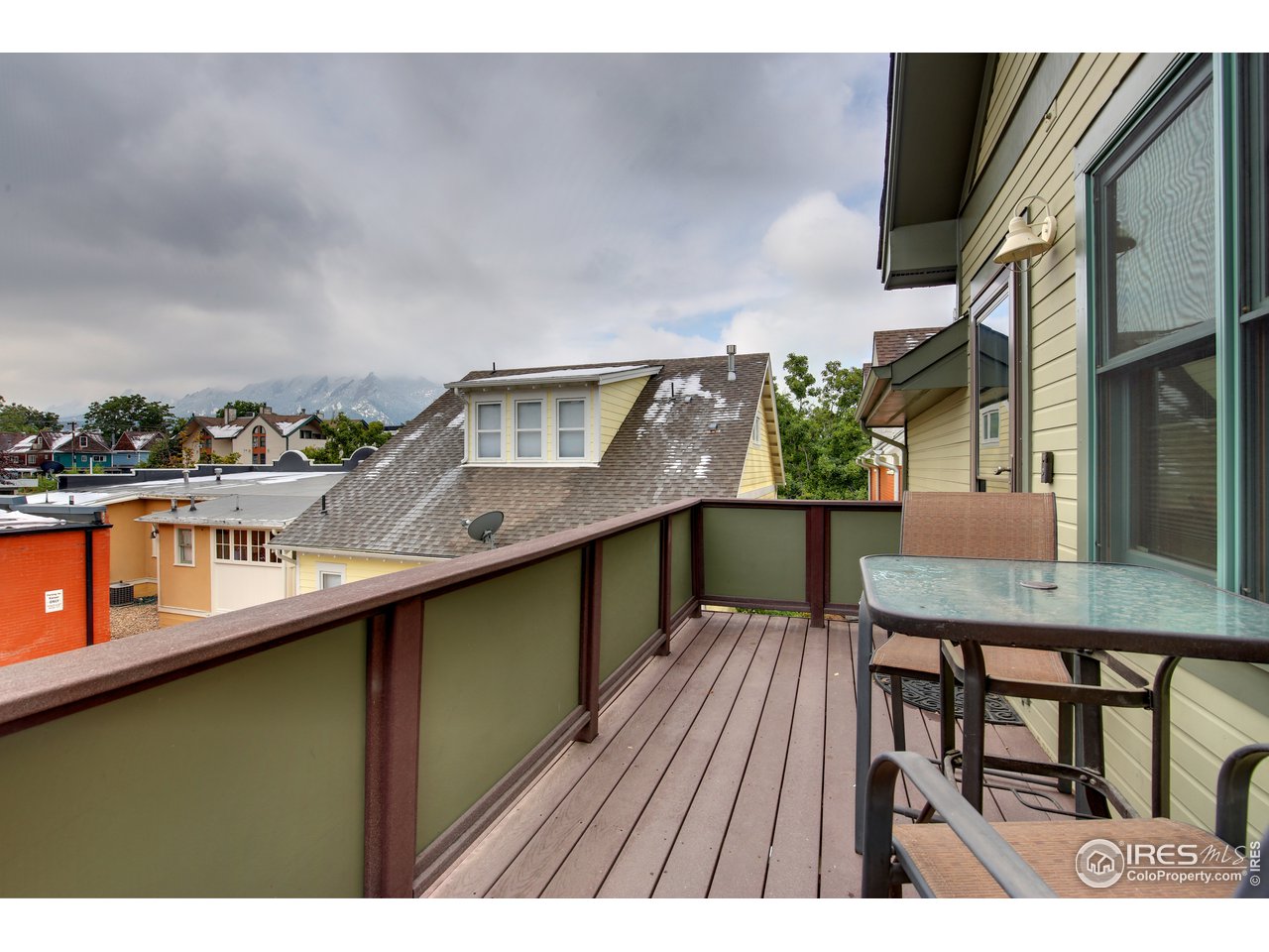 1933 Pearl Street, Unit 7 Boulder, CO 80302 - Photo 12 of 21 a balcony with wooden floor table and chairs